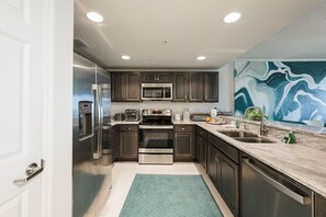 Enjoy cooking in this well-equipped kitchen with a microwave, toaster, and oven, along with a sink and faucet.