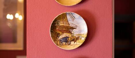 Three circular wall-mounted plates with historical scenes.
