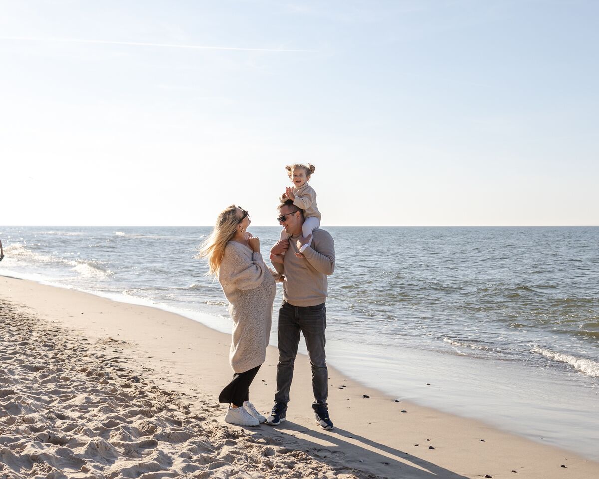 A beach scene with a sandy shore and a calm sea.