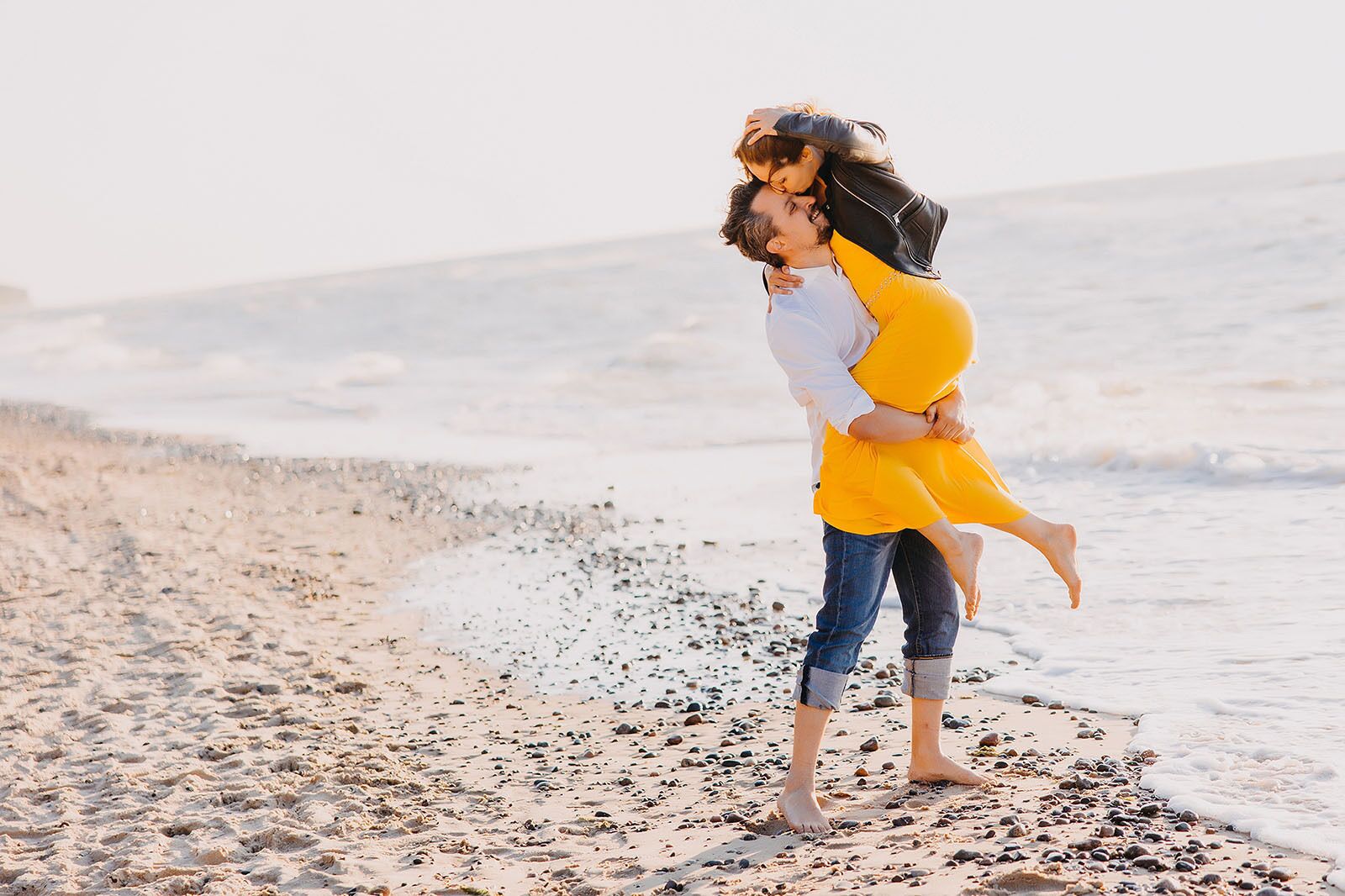 A couple on a beach with a clear view of the ocean.