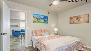 A bedroom with a bed, a nightstand, a ceiling fan, and a painting on the wall. - 735 NW 30th St, Apt 11 OKC (Oklahoma City)