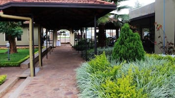 A covered walkway with a tiled roof, leading to a building entrance.