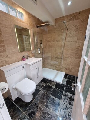 Shower, rainfall showerhead, hair dryer, towels