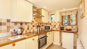 A kitchen with a microwave, kettle, and a small refrigerator. - Hedgehog Cottage, Wheddon Cross (Wheddon Cross)