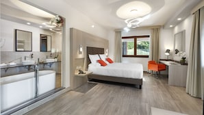 A modern hotel room with a large bed, a desk, a chair, a bathroom with a bathtub, and a large window with curtains. - BHotel (Lagonegro)