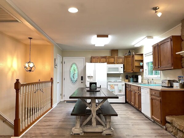 Enjoy cooking and dining in this well-equipped kitchen with a central island, dining table, and modern appliances.