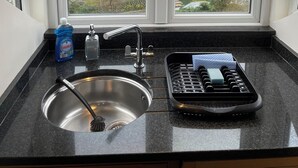 A kitchen with a window view of a residential street. - Stunning Whitby Penthouse Apartment with Abbey View (Whitby)