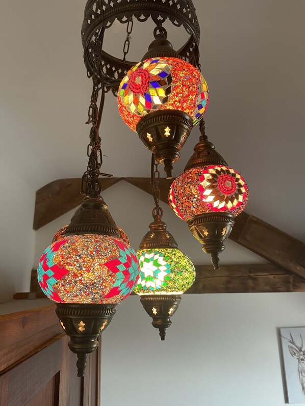 A set of ornate hanging lanterns with intricate mosaic designs.