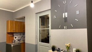 A modern kitchen with wooden cabinets, a built-in dishwasher, and a decorative backsplash. - Lares and Penates in Old Krakow,winter garden-5 min from the Rynok  Rynok Square (Kraków)