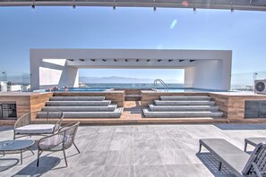 A rooftop pool area with a view of the sea and mountains. - Cruz 504: Studio w Rooftop Pool, 2 Blocks to Beach (Cruz de Huanacaxtle)
