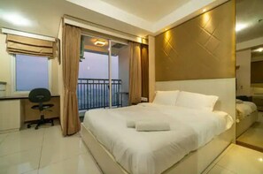 Relax in comfort with a large bed, desk, and balcony access.