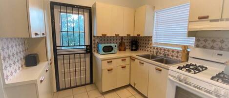 Fridge, coffee/tea maker, cookware/dishes/utensils