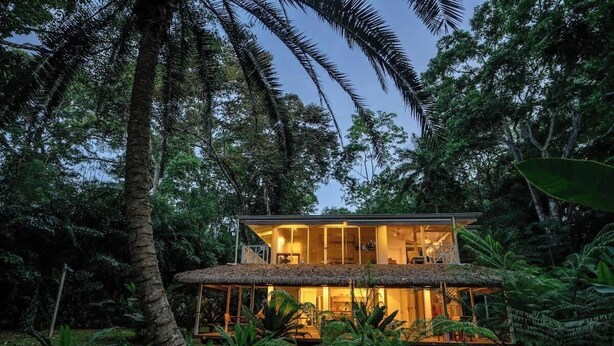 A two-story eco-friendly house surrounded by dense tropical foliage. - El Oasis Beachfront - Oceanfront Escape (Manzanillo)