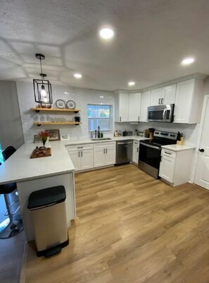 Fridge, microwave, oven, stovetop - Relax in Style at Our 3BR/2BA Retreat with Private Pool|Game Room|Fire Pit|Yoga (Tampa)