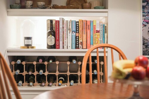 Juniper Cottage is a quaint, two-bedroom Grade II listed property featuring white wooden cladding.