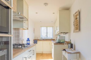 Fridge, microwave, oven, stovetop - Jubilee Cottage is a comfortable three-bedroom house featuring a sunny garden and private parking. (Whitstable)