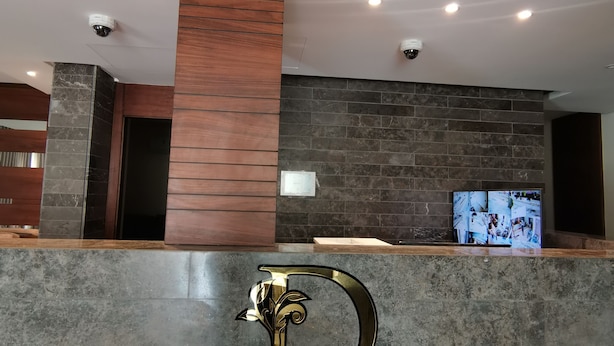 A reception desk with a large D logo and the text "DARA APARTMENT HOTEL" at the front. - Dara apartment hotel (Amman)