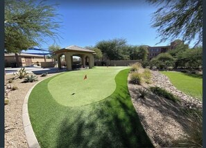 Enjoy a round of golf on our well-maintained course, surrounded by lush shrubs and trees.