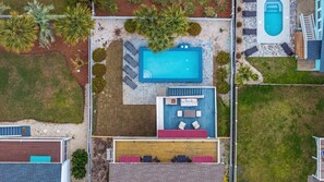 An aerial view of a residential property with a swimming pool, outdoor seating area, and a covered patio. - 5BR Beach House w/ Heated Pool | Great Views! (North Myrtle Beach)