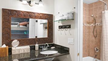 Bathtub, eco-friendly toiletries, hair dryer, towels