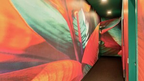 A hallway with a vibrant, abstract mural on the walls. - Rugs Hotel Augsburg, Trademark Collection by Wyndham (Augsburg)