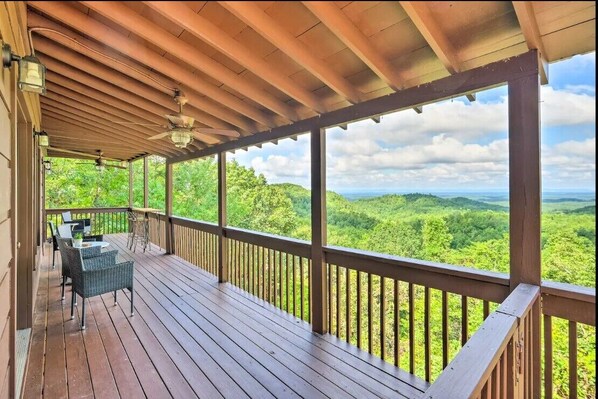 A wooden deck with a view of a lush green landscape. - Good 2 View Mountain Views Game Room Sleeps 12 (Ranger)