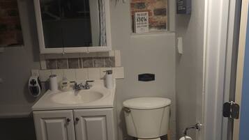 Shower, rainfall showerhead, hair dryer, towels