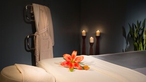 A spa room with a massage table, a towel, and candles. - 2900sqft villa near ski & snowboarding (Tobyhanna)