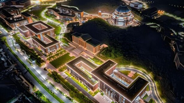 An aerial view of a modern urban development with interconnected buildings, roads, and green spaces. - U-FREE Hotel (Dongguan Xiegang Square) (Dongguan)
