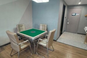 A room with a pool table, four chairs, a door, and a sink. - U-FREE Hotel (Dongguan Xiegang Square) (Dongguan)