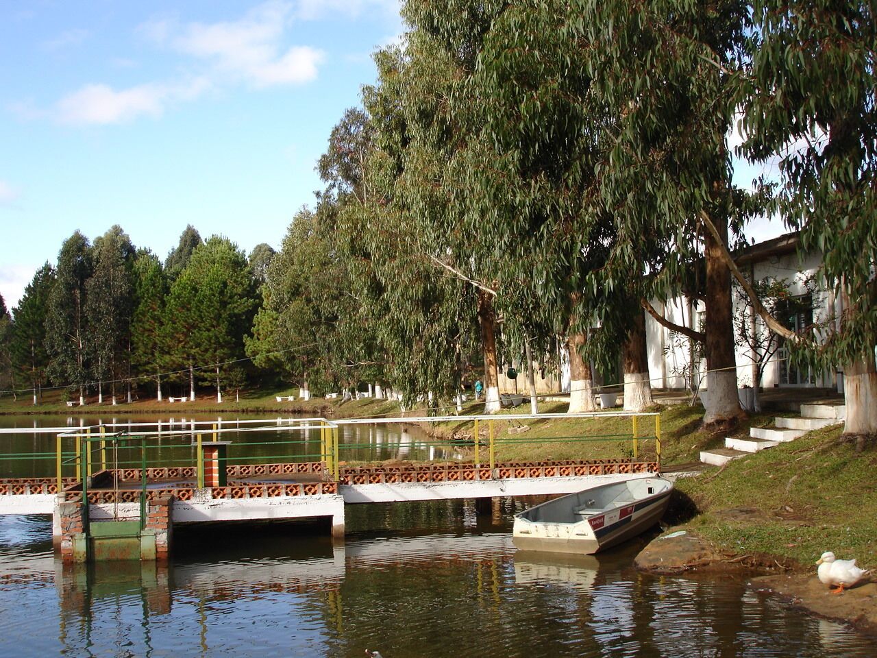 A calm water body with a small dock and a boat.