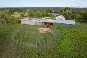 A rural property with a fenced area, a barn, and a green building. - 6 Tiny Town + Monthly + Utilities + Comfy Stay (Hico)