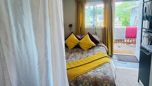 A bedroom with a bed, curtains, a window, and a view of the outside. - Book one week or more and get 10% discount
Stylish 2 BR Suite in West Seattle!
 (Seattle)