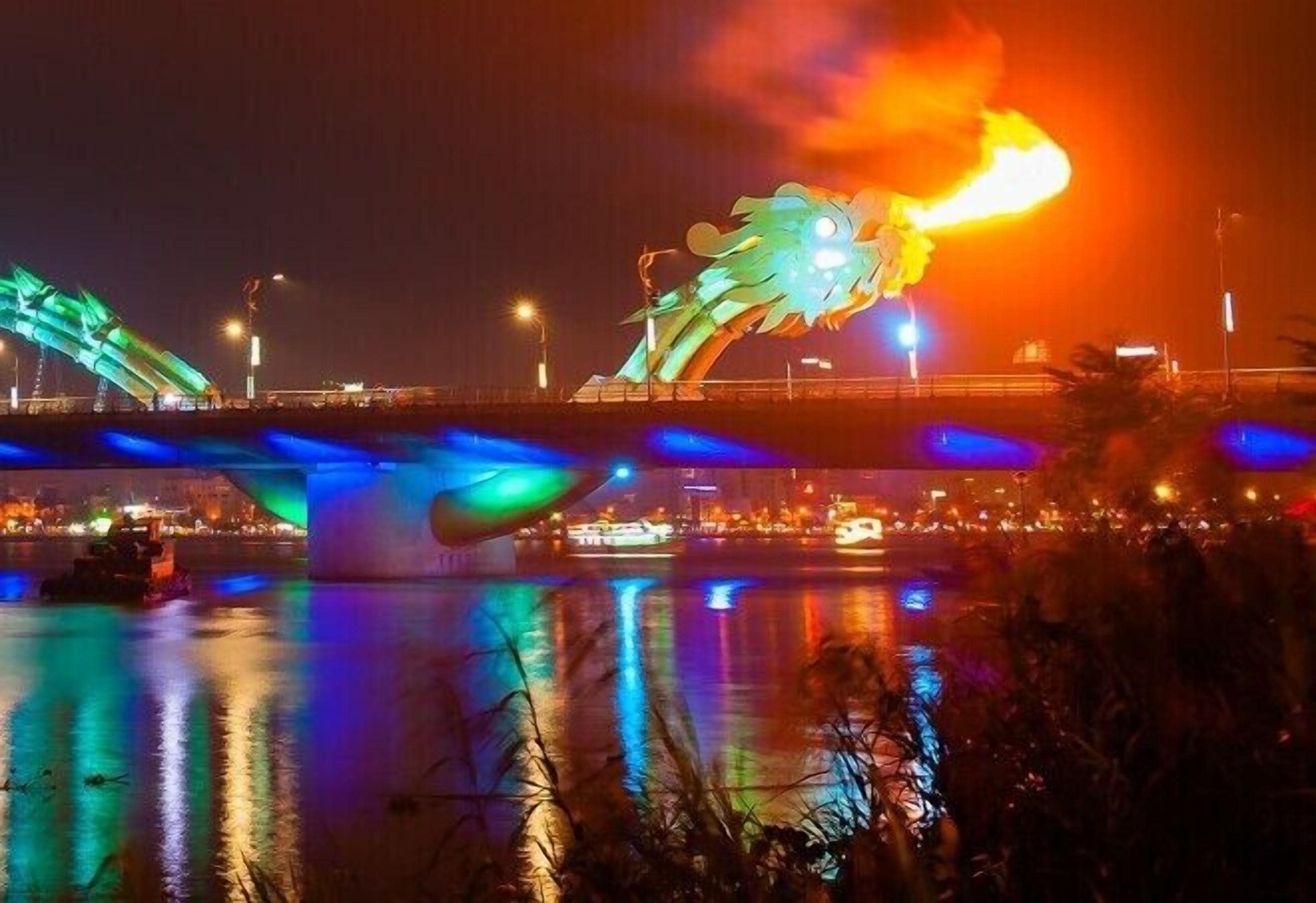 A bridge with a dragon sculpture and colorful lights.