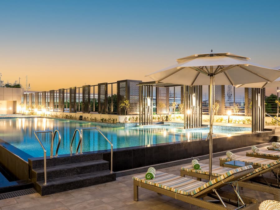 Outdoor pool, open 7:00 AM to 7:00 PM, pool umbrellas, sun loungers