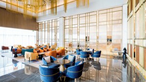 A spacious lobby with modern seating arrangements and large windows.