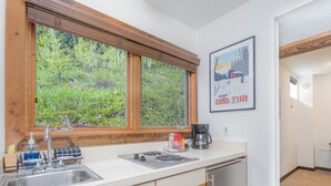 A kitchen with a window, a coffee maker, and a sink. - Manitou Lodge 4 Hotel Room by Alpine Lodging Telluride (Telluride)