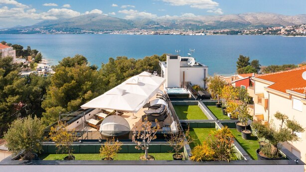A rooftop terrace with a pool, outdoor seating, and a view of the sea and mountains. - Beach Villa Valentina Apartment IX (Okrug Gornji)