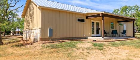 A single-story building with a covered porch and a metal roof.