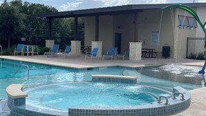 A swimming pool with lounge chairs and a hot tub. - Elegant and cozy 3 bedroom/2 full bath new home (San Antonio)