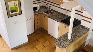 Een koelkast, een magnetron, een kookplaat, een vaatwasser