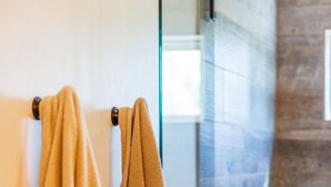 A bathroom with two towels hanging on a towel rack.