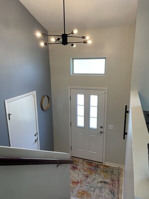 Enter a cozy retreat with an entrance, comfortable rug, and functional decor.