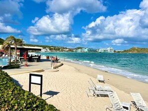 Guests can enjoy stunning ocean views and relax by the pool surrounded by palm trees.