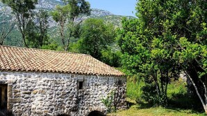 A rustic stone building with a tiled roof, a small window, and a stone archway. - Attractive House with A/C, Private Pool, Superb Views of the Konavle Valley, 5 mins walk to Gruda! (Gruda)