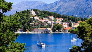 A coastal town with buildings, a church, and a clear blue sea. - Attractive House with A/C, Private Pool, Superb Views of the Konavle Valley, 5 mins walk to Gruda! (Gruda)