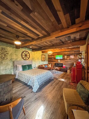 Relax in this charming bedroom with a large bed, wooden headboard, and cozy seating area.