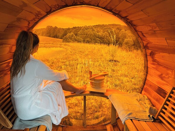 Guests can enjoy a serene atmosphere in this peaceful retreat, surrounded by a grassy field and trees.