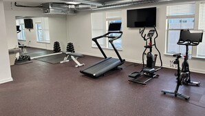 A gym with treadmills, an elliptical, and free weights. - Downtown Memphis Loft! Walking distance from Beale street! Garage parking! (Memphis)