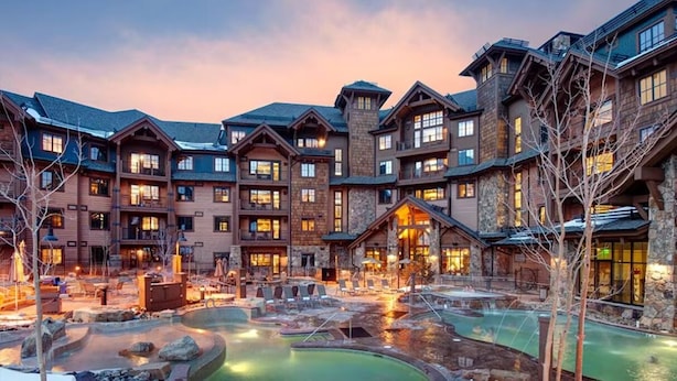 A multi-story hotel with a courtyard featuring a hot tub and lounge area. - Grand Lodge Peak 7, Breckenridge 20-27 Dec, ski in/ski out resort 2 Bdrm/2 bath (Breckenridge)